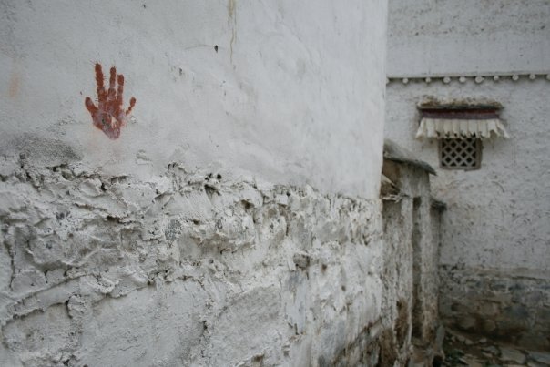 Tibet Red Handprint on wall  - Jessika Pilkes